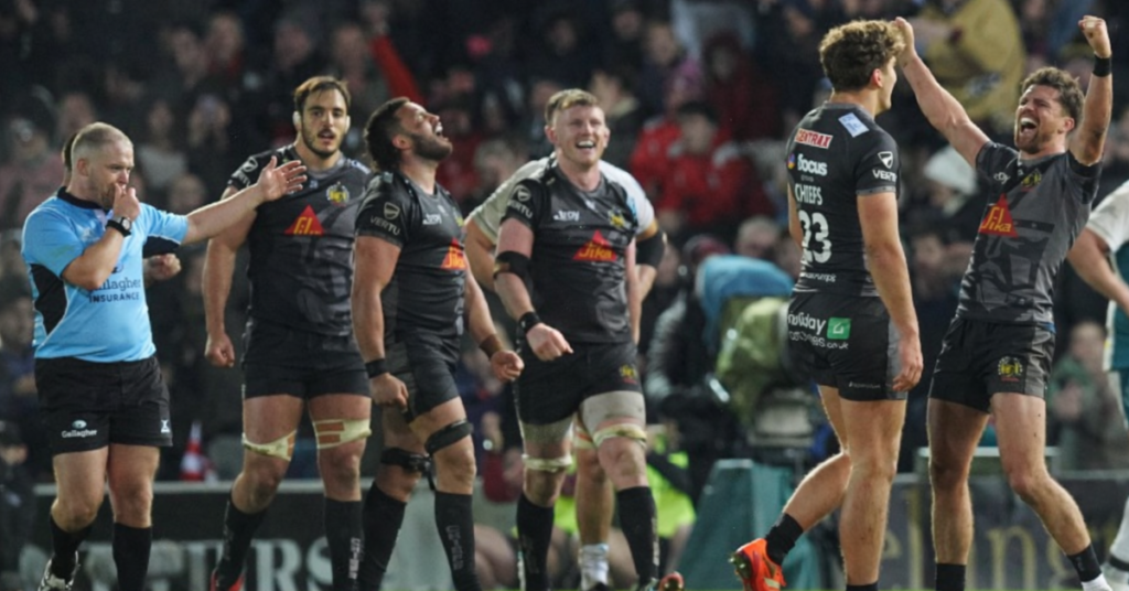 Esher Rugby Club players executing a tackle during a competitive match